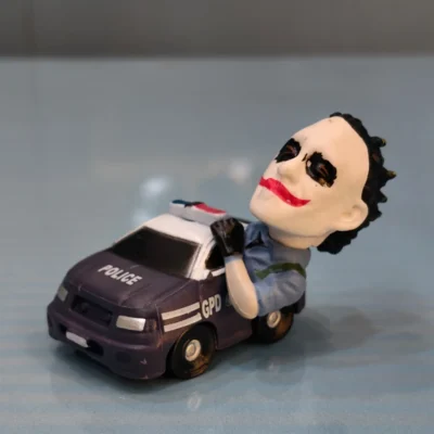 Clown Prince of Crime Riding a Gotham Police Car